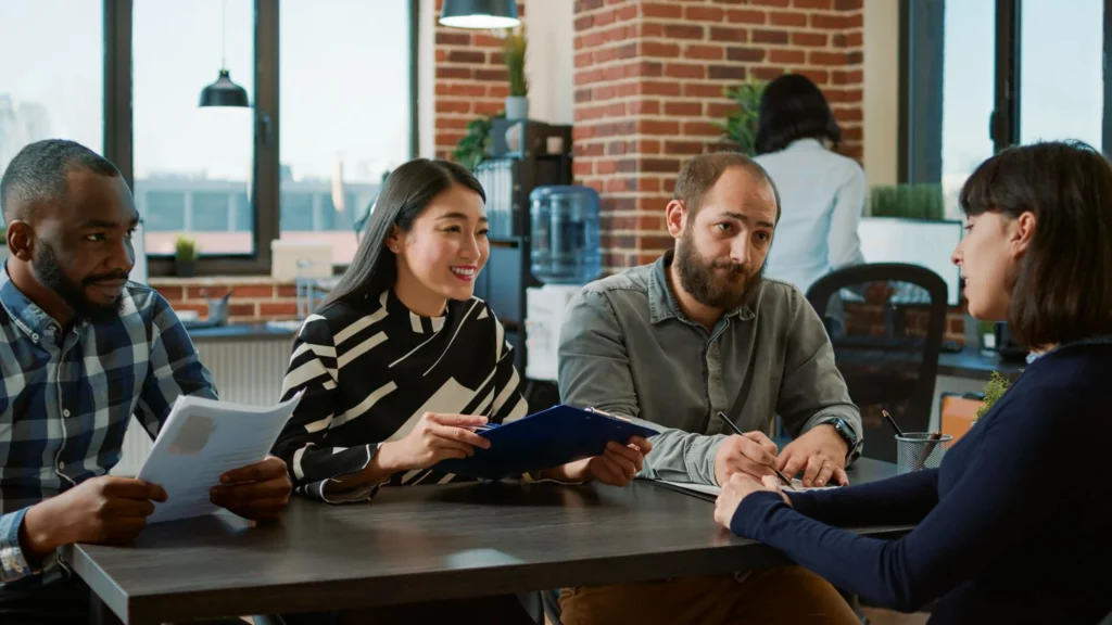Diverse professional team reviewing documents for an Australian employer-sponsored visa 186.
